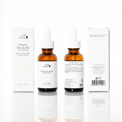 Closeup of 100% PURE Marula Oil label highlighting vegan, cold-pressed purity for radiant skin
