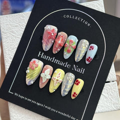 Almond medium nails with gradient and floral patterns for versatile style.