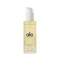 Alo Head-to-Toe Glow Oil bottle closeup showing radiant citrus hydration.