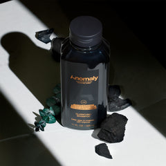 Anomaly bottle label closeup highlighting vegan and sulfate-free formula