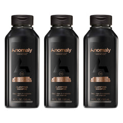 Anomaly clarifying shampoo bottle pour showing charcoal cleanse for buildup control