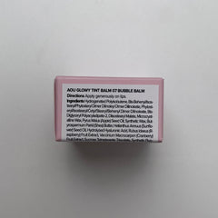 AOU Glowy Tint Balm tube held for travel-friendly use