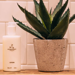 Aromatherapy Associates Hand and Body Lotion featuring ylang-ylang, geranium, and patchouli essential oils for uplifting calm