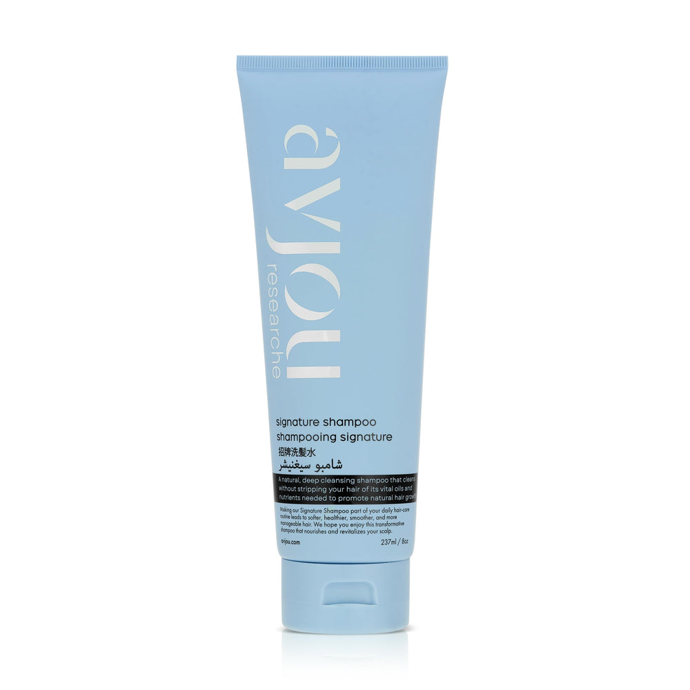 Avjou Researche Signature Shampoo bottle close-up highlighting hydration-rich formula for smooth, shiny hair.