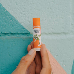 Badger Tangerine Breeze lip balm with citrus oils offers a bright, refreshing scent.