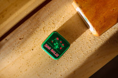 Bag Balm skin moisturizer applied to the hand for quick hydration.