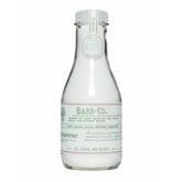 Barr-Co fir grapefruit bath salts jar shown in glass for relaxing soaks.