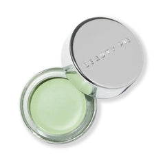Beauty Pie Superluminous Redness Corrector Green bottle on a vanity, quick redness neutralization.