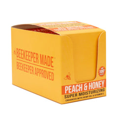 Beekeeper Made peach scented lip balm application image shows easy lip nourishment.
