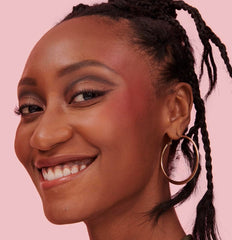 Close-up brush stroke with Moone blush for natural glow.