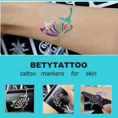 Betytattoo hand drawing on skin shows quick-dry color markers.