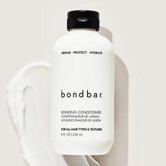Close-up of glossy Bondbar-treated hair with smooth finish.
