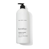 Bondbar Repairing Shampoo bottle close-up highlighting hydrating formula for all hair types.
