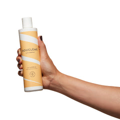 Boucleme Curl Conditioner applied to damp hair for detangling