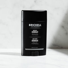 Brickell natural deodorant unscented stick being applied for smooth skin protection
