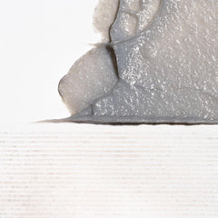 Binchotan charcoal exfoliant close-up showing plant-based micro-particles for gentle cleansing.