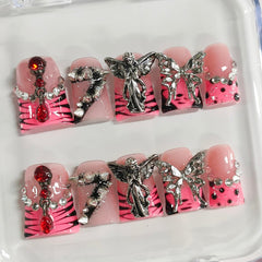 BRKYKGK nails with angel charms and rhinestones for a gothic sparkle
