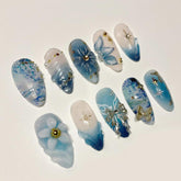 BSBTBZ blue press on nails in almond shape with gold beads for a radiant finish.