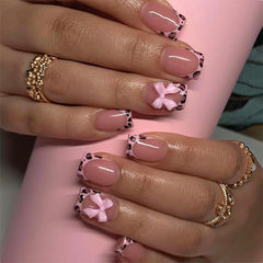 BSBTBZ leopard French tip nails with pink glossy bow close-up for chic at-home manicure