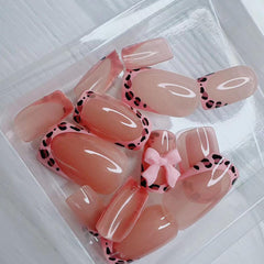 BSBTBZ leopard French tip nails with pink glossy bow in packaging