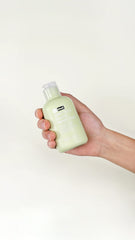 Close-up of BY WISHTREND powder wash texture with enzyme particles and green tea.