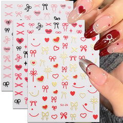 Vivid heart bow design in red, white and black for chic nail art.