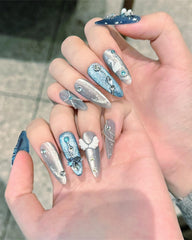 CAMILCY hand-painted almond nails featuring blue diamonds for party wear