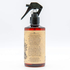 Bay Rum Hair Tonic being poured for easy application and scalp refreshment.