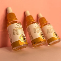 Close-up of toner being applied with a cotton pad using Class Gold branding