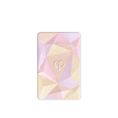 Clé de Peau Beauté Luminizing Face Enhancer 110 opal powder reflection creates shimmering glow.