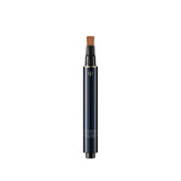 Clé de Peau Beauté Radiant Corrector for Eyes Toffee conceals dark circles with a luminous finish.