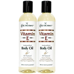 COCOCARE Vitamin E body oil bottle at an angle highlighting hydration for all skin types.