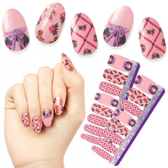 Color Street Baking Season pink glitter nails with gingerbread and holly for a festive holiday manicure.