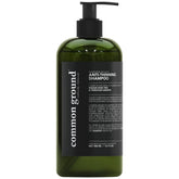 Common Ground shampoo bottle highlighting bergamot-rosemary scent for a refreshing wash.