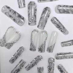 CTTHNBD silver French-tip nails with heart design for chic party or date-night manicure