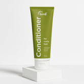 Curly Bird Deep Curl Conditioner packaging highlights easy-use bottle for quick application.