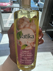 Close-up of garlic essence in Dabur Vatika Enriched Hair Oil for nourishing care.
