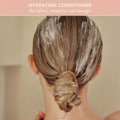 Close-up of conditioner being applied for detangling and reduced breakage.