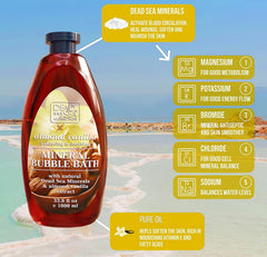 Dead Sea Collection bottle pouring almond vanilla bubble bath for a spa-like soak.