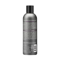 Close-up of Design Essentials peppermint aloe anti-itch shampoo label highlighting zinc-based formula for flake control.