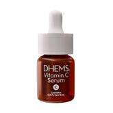 DHEMS Vitamin C Serum bottle pour demonstrates quick absorption for a refreshed, radiant complexion.