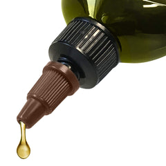 Difeel bottle texture close-up showing conditioning oil on hair strands.