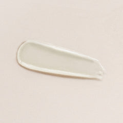 Close-up of DIME Lip Balm jar reveals creamy, nourishing texture.
