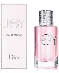 Dior Joy bottle close-up highlighting vibrant citrus and floral notes.