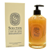 Diptyque Solution Exfoliating Hand Wash bottle close-up showing olive-stone exfoliation for smoother skin.