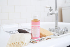 Pouring Dr. Bronner's Cherry Blossom soap to show easy dilution