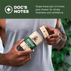 Swiping underarm with Dr. Squatch Pine Tar deodorant for quick application.