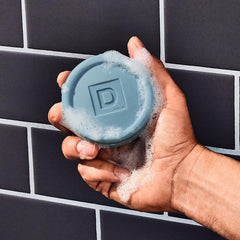 Duke Cannon Midnight Swim in shower scene, refreshing aquatic fragrance during grooming.