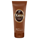 Ed Hardy Coconut Kisses Golden Tanning Lotion bottle on a sunny display for hydration.