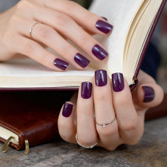 Elevenail nails on fingertips showing medium squoval shape and shine